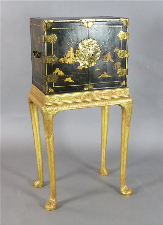 An early 18th century Japanese black lacquer cabinet, cabinet W.1ft 7in. D.1ft H.1ft 4in. Overall W.1ft 9in. D.1ft 3in. H.3ft 6.5in.